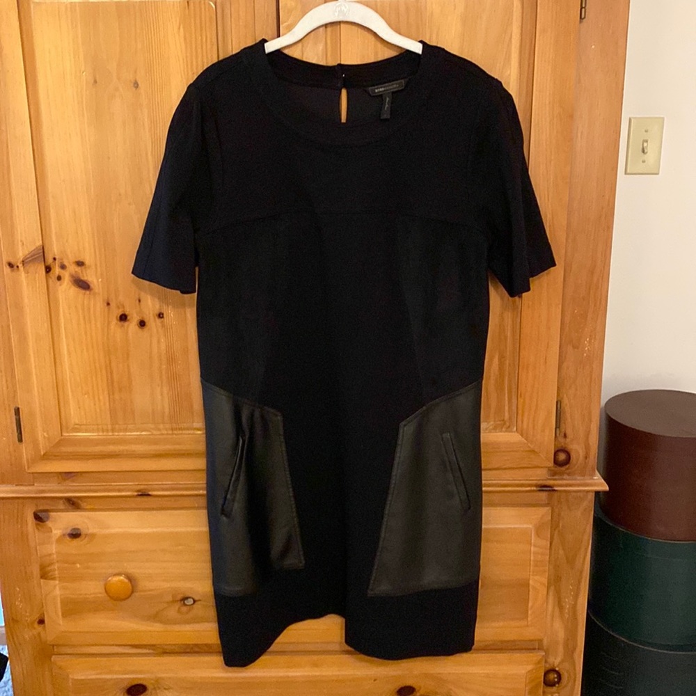 BCBG black A-line dress with vegan leather and suede accents.